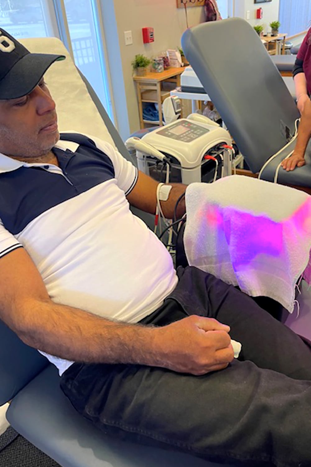 man getting laser light therapy hand treatment