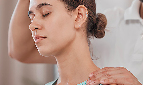 Woman with neck pain having chiropractice services done.